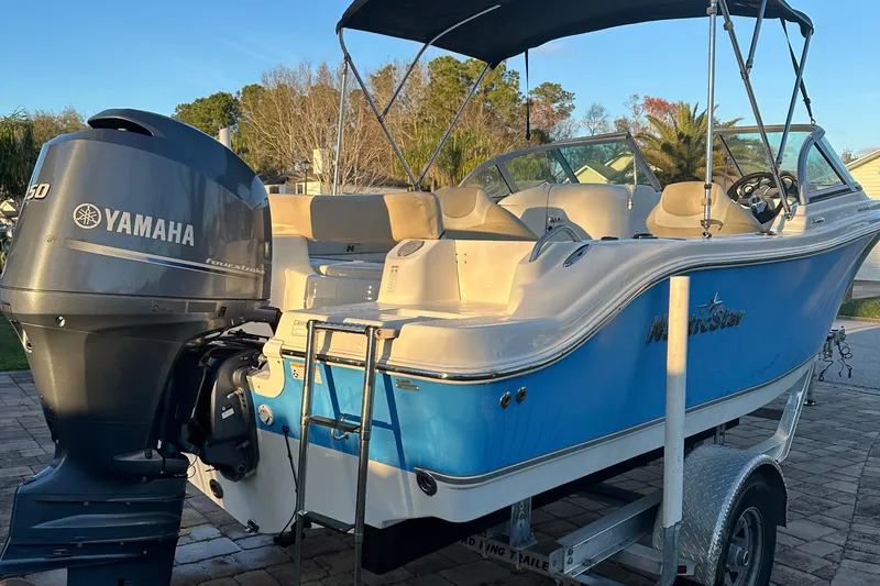 Slide: The Image of 2015 NauticStar 2000 XSDC boat with Yamaha engine on trailer. - 26