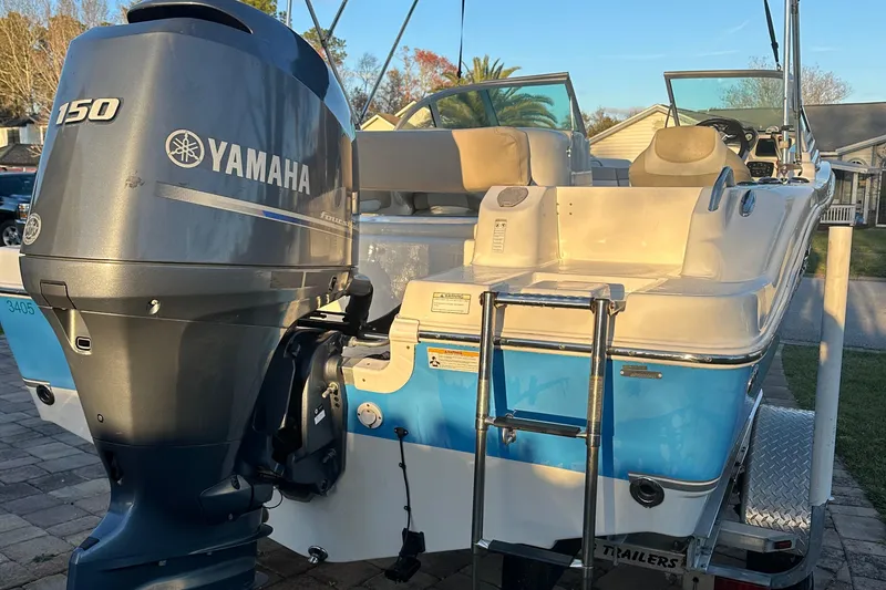 Slide: The Image of 2015 NauticStar 2000 XSDC boat with Yamaha 150 engine, docked outdoors. - 28