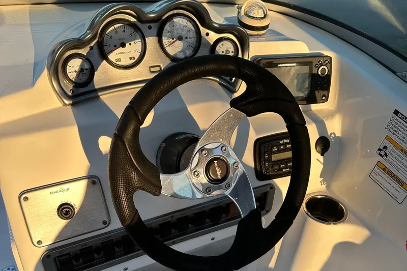 Slide: The Image of Dashboard of 2015 NauticStar 2000 XSDC boat with steering wheel and gauges. - 37