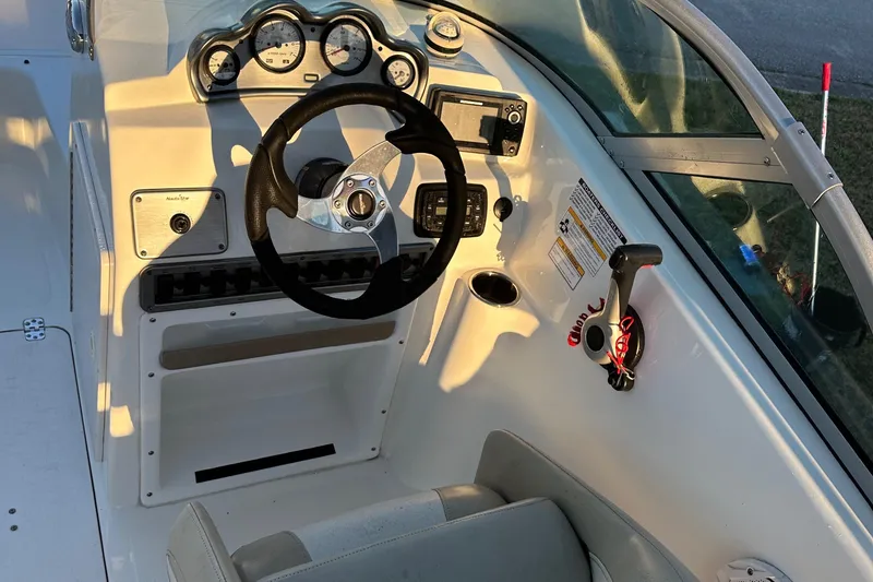 Slide: The Image of 2015 NauticStar 2000 XSDC boat dashboard with steering wheel and controls. - 38