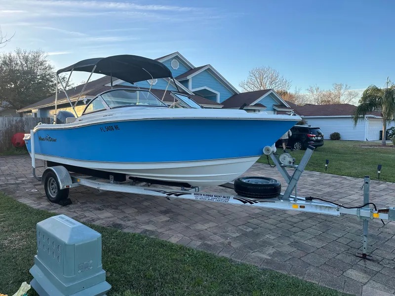 Slide: The Image of 2015 NauticStar 2000 XSDC boat on trailer in residential driveway. - 4
