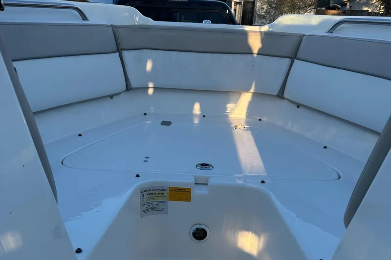 Slide: The Image of 2015 NauticStar 2000 XSDC boat interior with cushioned seating and storage area. - 41
