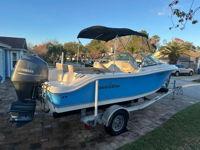 Slide: The Image of 2015 NauticStar 2000 XSDC boat on trailer with Yamaha engine, parked outdoors. - 9
