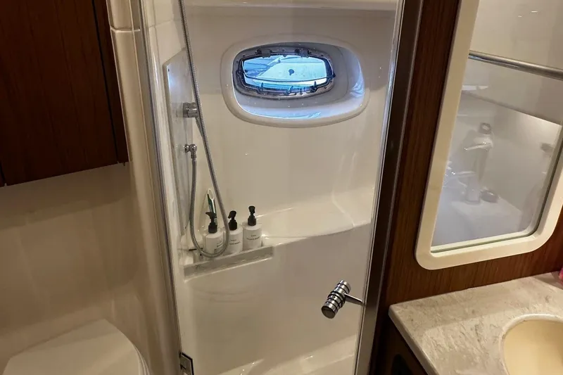 Slide: The Image of Bathroom interior of 2023 Tiara Yachts 43 Open, featuring shower and porthole window. - 11