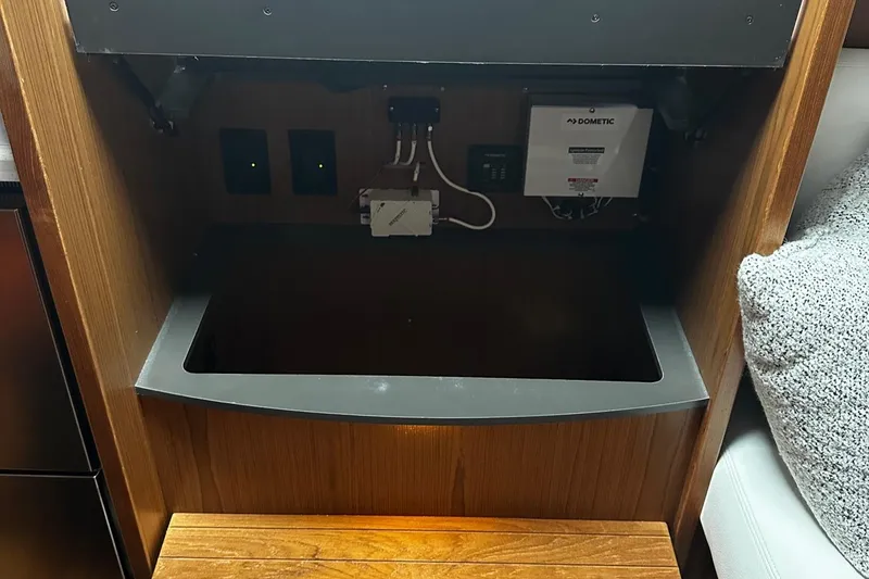 Slide: The Image of 2023 Tiara Yachts 43 Open interior electrical panel with wooden finish. - 16