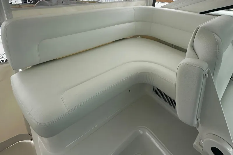 Slide: The Image of 2023 Tiara Yachts 43 Open, white L-shaped seating area, luxurious interior design. - 19