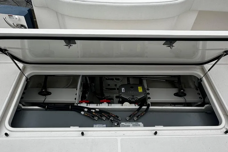 Slide: The Image of 2023 Tiara Yachts 43 Open engine compartment with visible components and wiring. - 28