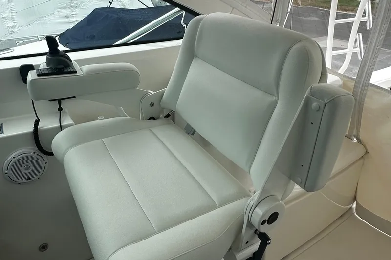Slide: The Image of Captain's chair on 2023 Tiara Yachts 43 Open, featuring sleek white upholstery. - 3