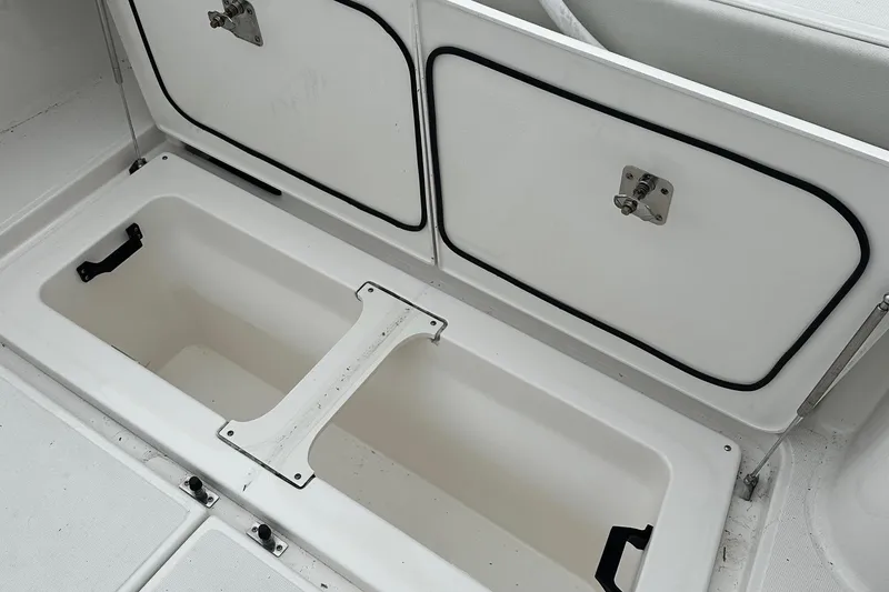 Slide: The Image of Storage compartment on 2023 Tiara Yachts 43 Open boat, featuring secure latches and spacious interior. - 30