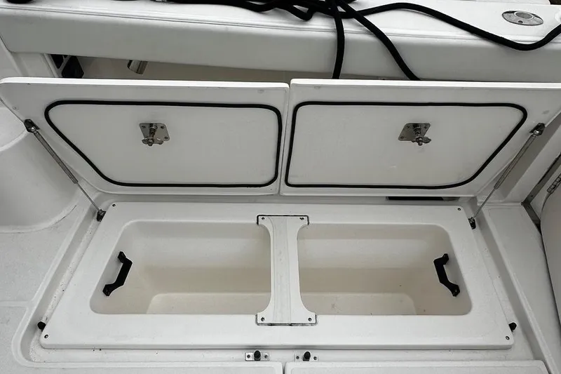 Slide: The Image of 2023 Tiara Yachts 43 Open storage compartment with dual hatches and handles. - 31