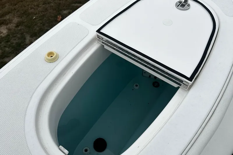 Slide: The Image of 2023 Tiara Yachts 43 Open livewell with open lid, showcasing interior details. - 35