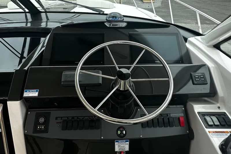 Slide: The Image of 2023 Tiara Yachts 43 Open helm with modern controls and sleek steering wheel. - 5