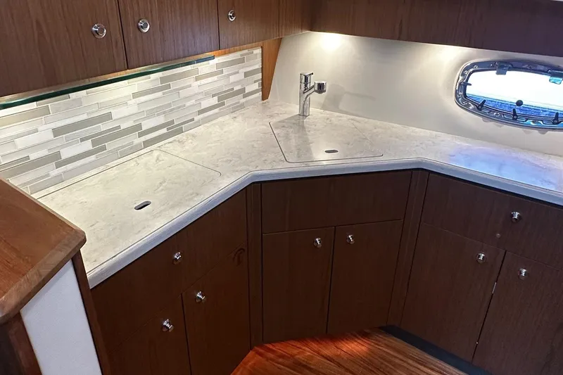 Slide: The Image of 2023 Tiara Yachts 43 Open kitchen with modern cabinetry and sleek countertop design. - 6