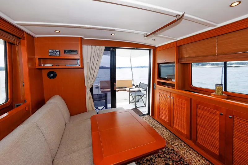 Slide: The Image of 2016 Beneteau Swift Trawler 44 interior with cozy seating and elegant wood finishes. - 14