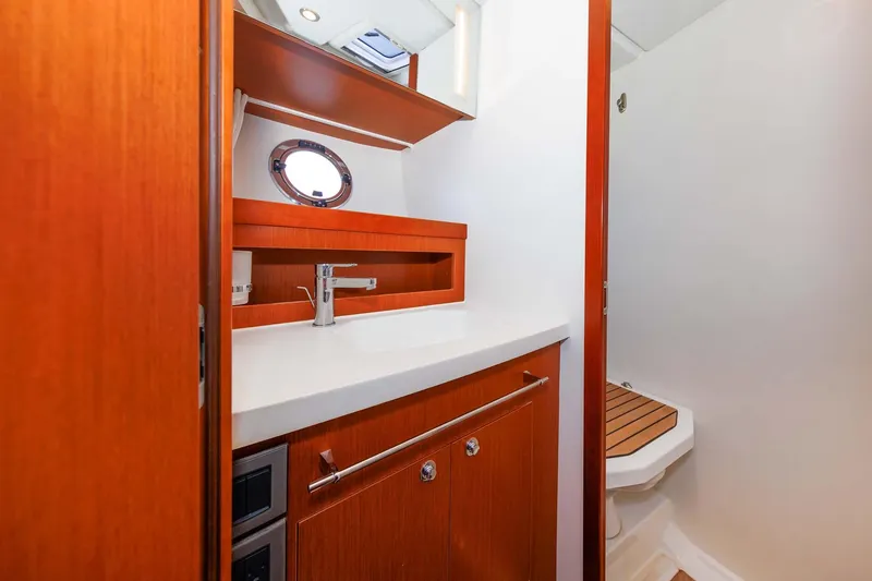 Slide: The Image of 2016 Beneteau Swift Trawler 44 bathroom with wooden cabinetry and modern fixtures. - 21