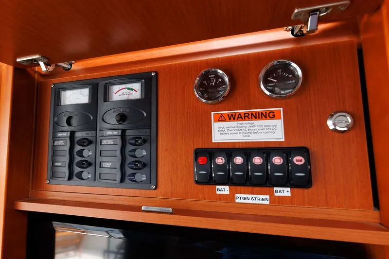 Slide: The Image of Control panel of 2016 Beneteau Swift Trawler 44 with gauges and warning label. - 26