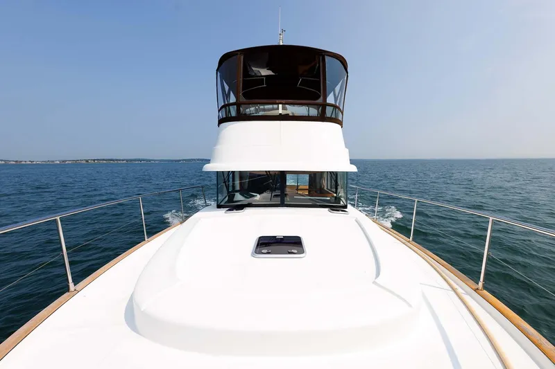 Slide: The Image of 2016 Beneteau Swift Trawler 44 cruising on open water, showcasing sleek design and spacious deck. - 34