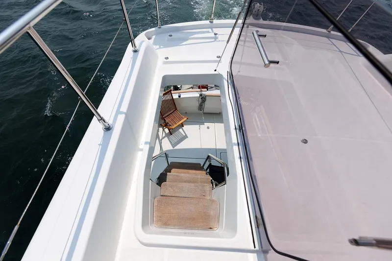 Slide: The Image of 2016 Beneteau Swift Trawler 44 deck with stairs and seating area. - 47