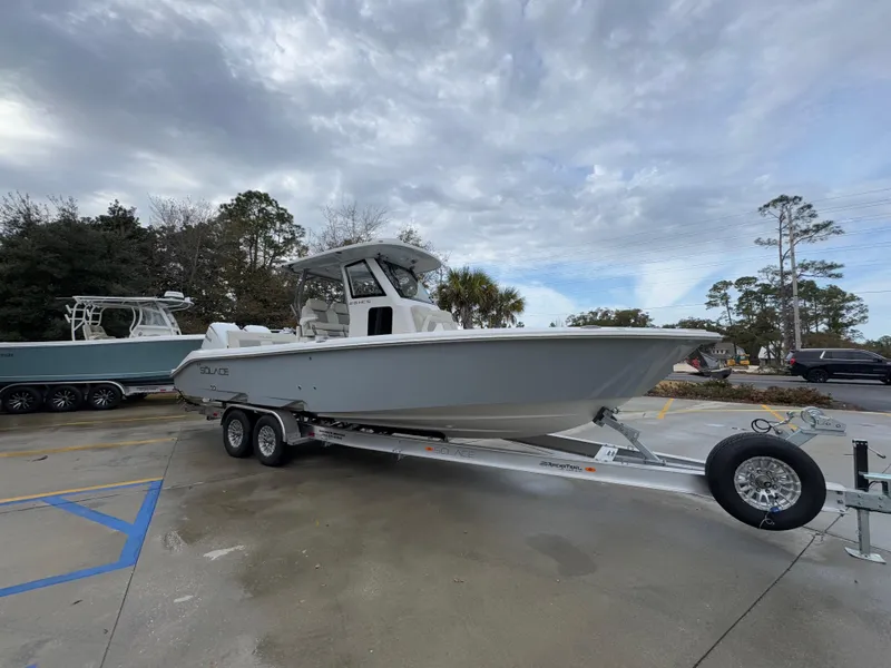 Slide: The Image of 2025 Solace 28 HCS boat on trailer under cloudy sky. - 10
