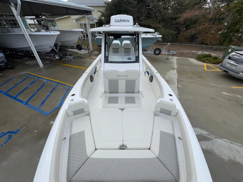 Slide: The Image of 2025 Solace 28 HCS boat with Garmin equipment, docked at a marina. - 25