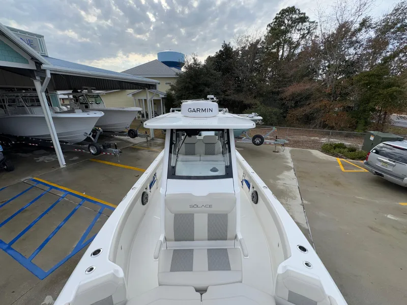 Slide: The Image of 2025 Solace 28 HCS boat with Garmin equipment, docked at a marina. - 26