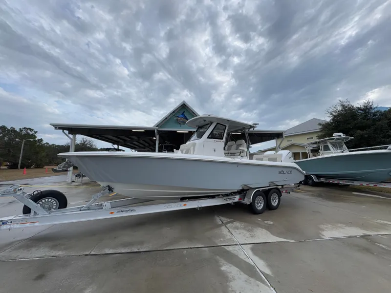 Slide: The Image of 2025 Solace 28 HCS boat on trailer under cloudy sky. - 3