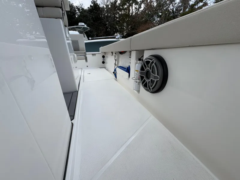 Slide: The Image of 2025 Solace 28 HCS boat interior with speaker and storage compartments. - 31