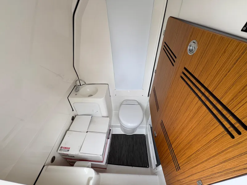 Slide: The Image of Compact bathroom in 2025 Solace 28 HCS boat with toilet, sink, and storage. - 33