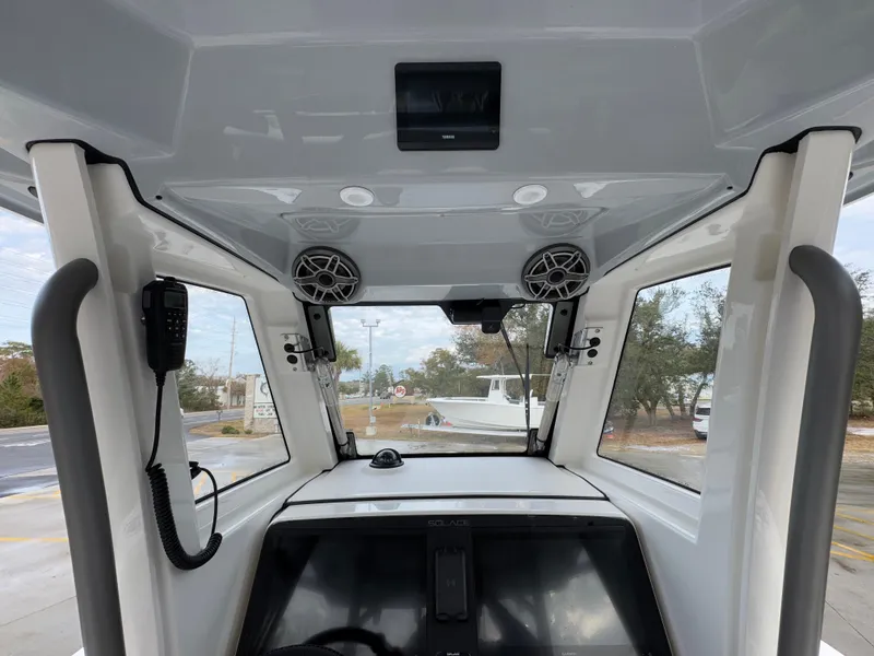 Slide: The Image of 2025 Solace 28 HCS boat interior with modern dashboard and speakers. - 39