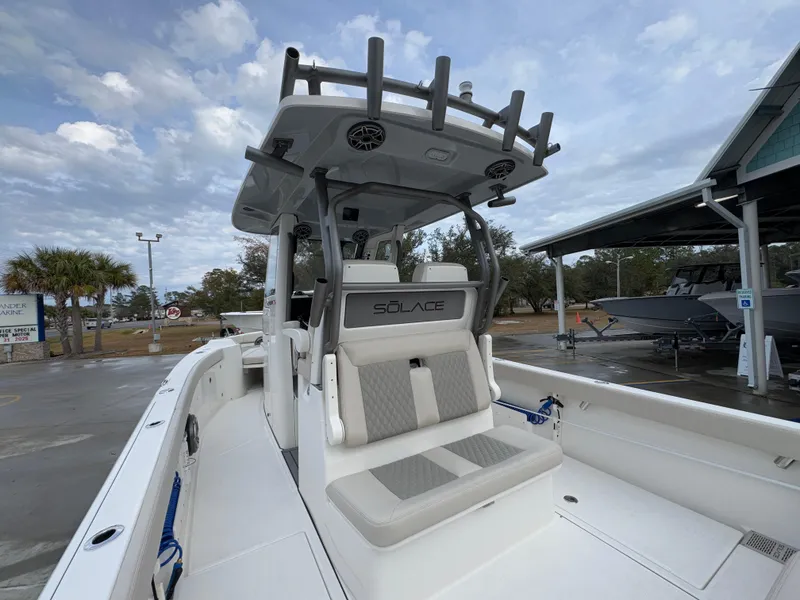 Slide: The Image of 2025 Solace 28 HCS boat with sleek seating and modern design in a marina setting. - 40