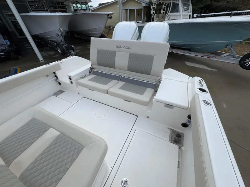 Slide: The Image of 2025 Solace 28 HCS boat interior with cushioned seating and modern design. - 42