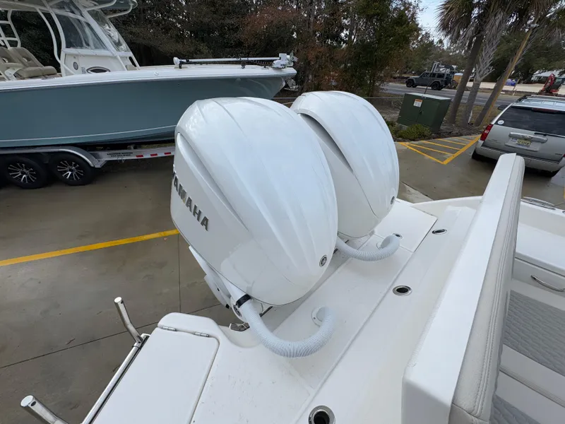 Slide: The Image of Twin Yamaha outboard engines on a 2025 Solace 28 HCS boat, parked outdoors. - 45
