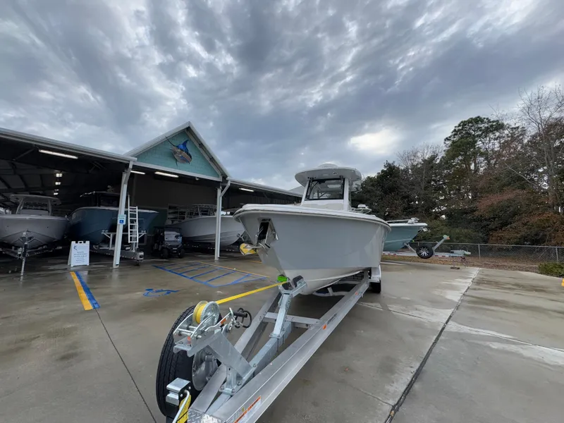 Slide: The Image of 2025 Solace 28 HCS boat on trailer at dealership under cloudy sky. - 7