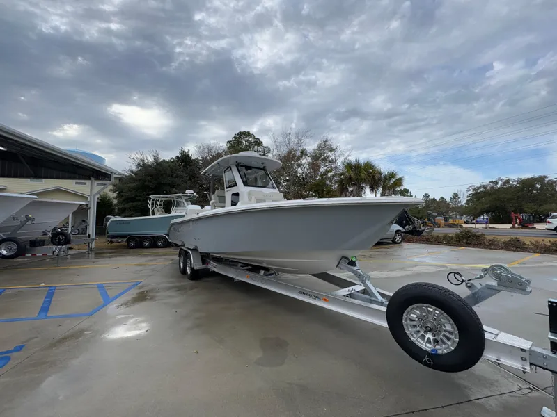 Slide: The Image of 2025 Solace 28 HCS boat on trailer under cloudy sky. - 9
