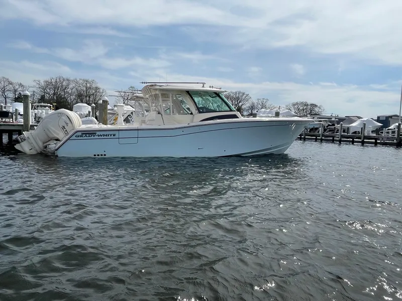 Slide: The Image of 2025 Grady-White Canyon 386 boat docked on a sunny day. - 13