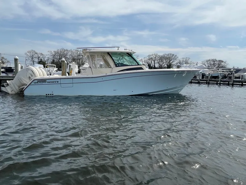 Slide: The Image of 2025 Grady-White Canyon 386 boat on water, side view, clear sky background. - 14