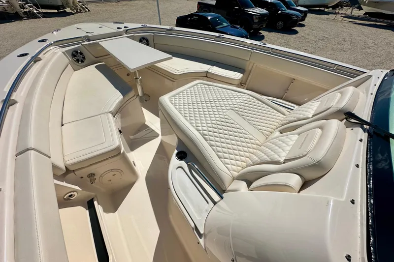 Slide: The Image of Luxurious seating area on 2025 Grady-White Canyon 386 boat, featuring plush cushions and table. - 6
