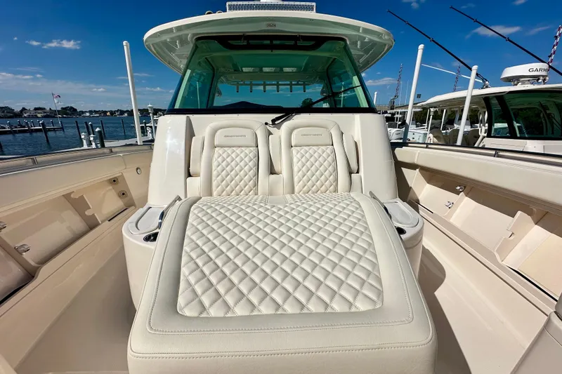 Slide: The Image of 2025 Grady-White Canyon 386 boat interior with luxurious seating and fishing rods. - 7