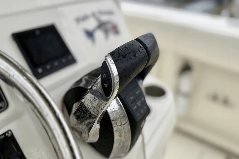 Slide: The Image of Close-up of 2015 Boston Whaler 280 Outrage boat controls with raindrops. - 13
