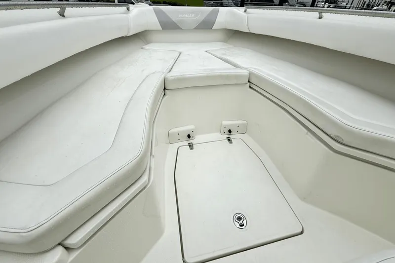 Slide: The Image of 2015 Boston Whaler 280 Outrage boat interior with white cushioned seating. - 15