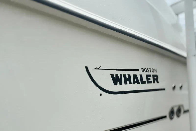 Slide: The Image of 2015 Boston Whaler 280 Outrage boat logo on white hull. - 3