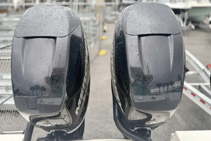 Slide: The Image of Twin Mercury outboard engines on a 2015 Boston Whaler 280 Outrage, wet with raindrops. - 5