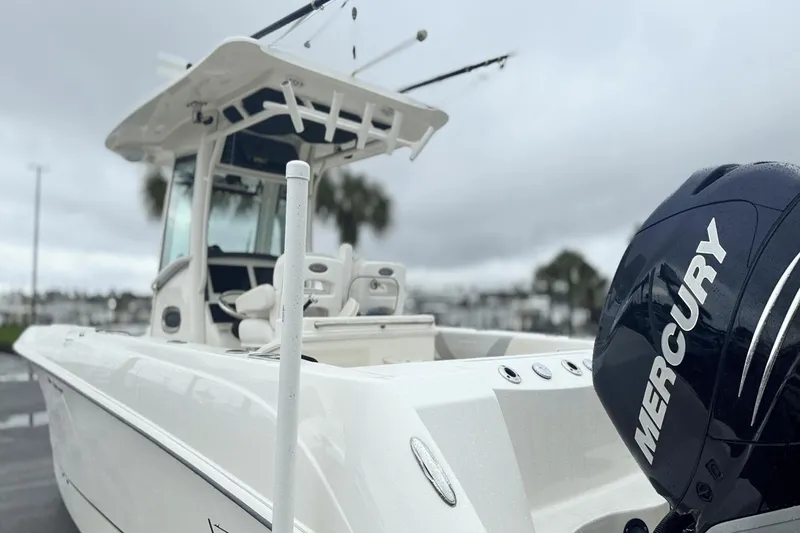 Slide: The Image of 2015 Boston Whaler 280 Outrage boat with Mercury engine, docked on a cloudy day. - 6