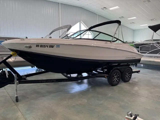Slide: The Image of 2023 Regal 2000 ES boat on trailer in indoor showroom. - 1