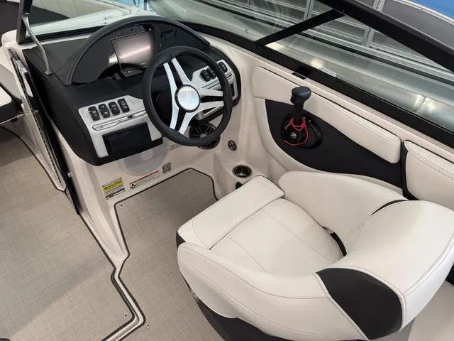 Slide: The Image of Interior of 2023 Regal 2000 ES boat, featuring modern steering and comfortable seating. - 13