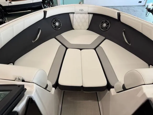 Slide: The Image of 2023 Regal 2000 ES boat interior with white and gray seating, featuring built-in speakers. - 16