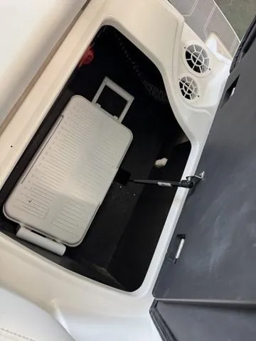Slide: The Image of 2023 Regal 2000 ES boat storage compartment with cooler and ventilation. - 17