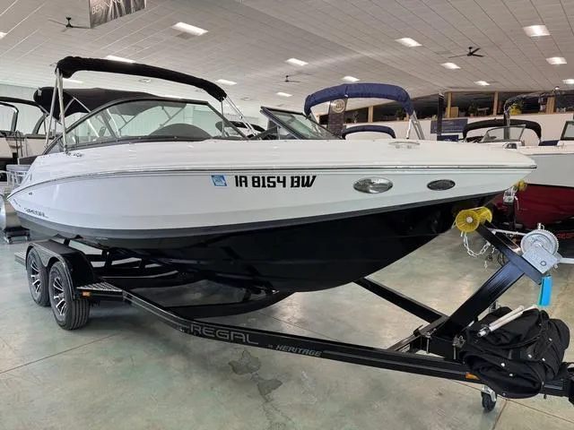 Slide: The Image of 2023 Regal 2000 ES boat on trailer in showroom, side view. - 2