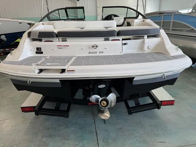 Slide: The Image of 2023 Regal 2000 ES boat, rear view in showroom, showcasing propeller and swim platform. - 4