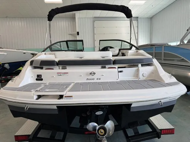 Slide: The Image of 2023 Regal 2000 ES boat in showroom, rear view with seating and propeller visible. - 5